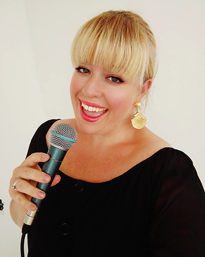 Lucy Kiely in black dress singing